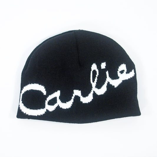 The Carlie - Black Beanie features the name "Carlie" in large, white cursive letters written diagonally across the front.